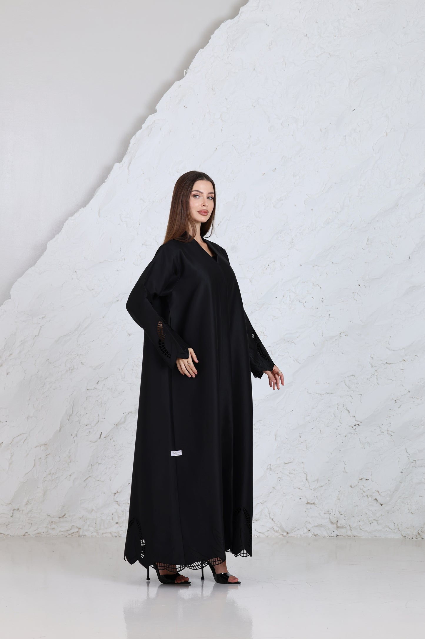 Close-up of black abaya fabric with embroidered sleeve detail for traditional & ceremonial clothing