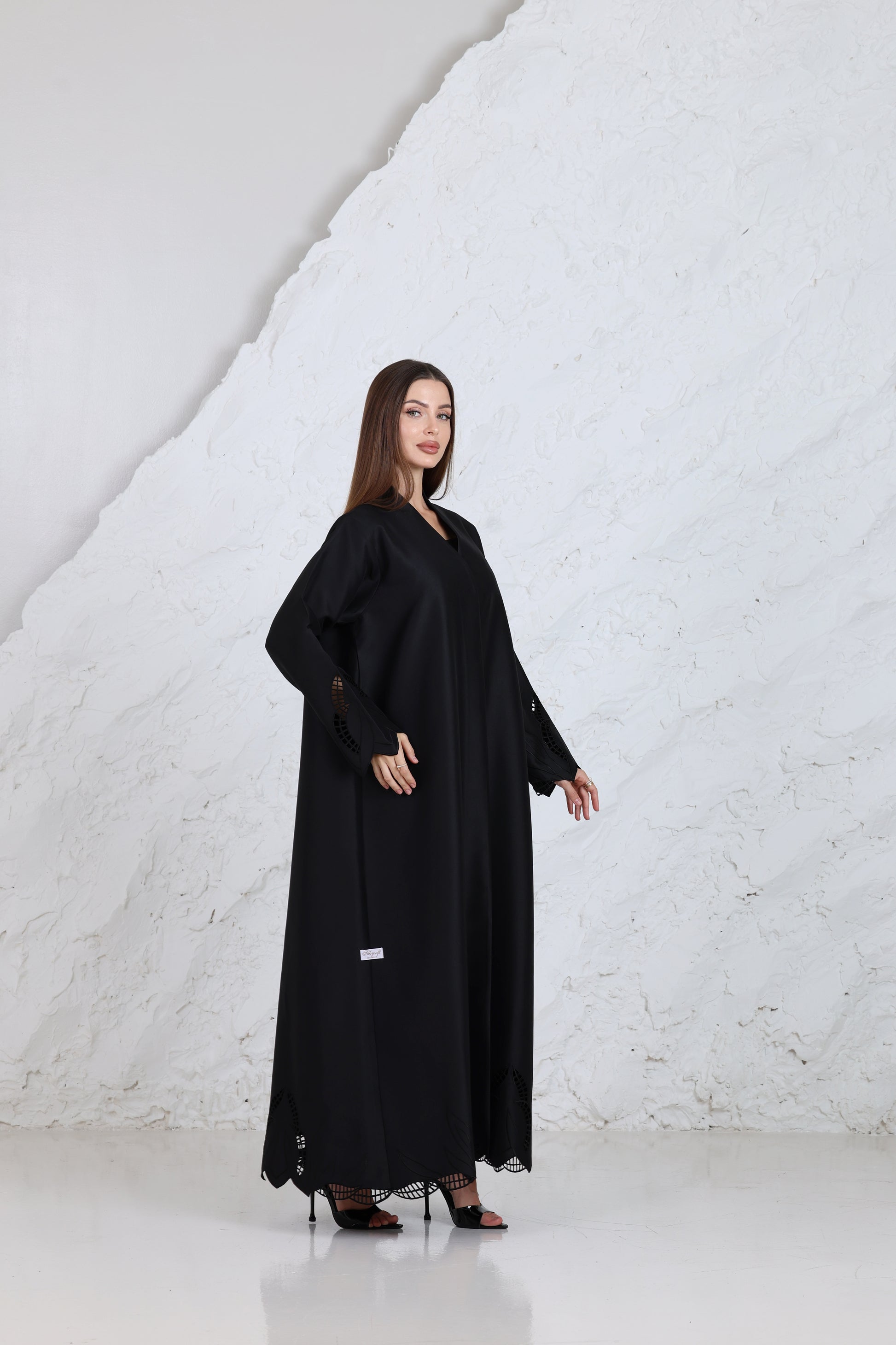 Close-up of black abaya fabric with embroidered sleeve detail for traditional & ceremonial clothing